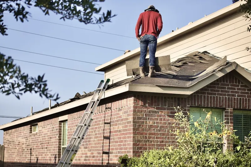 Professional roofer working on a residential roof in Seymour Johnson Homes